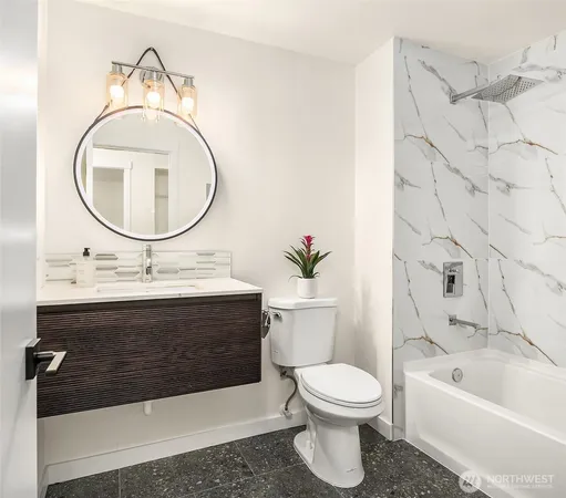 a bathroom with a sink a toilet and a mirror