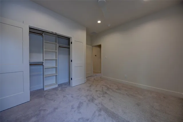 an empty room with closet and cabinet