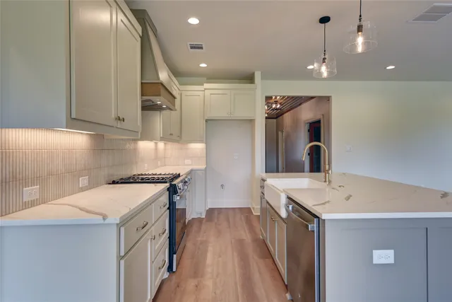 a kitchen with a sink a stove a refrigerator and a stove