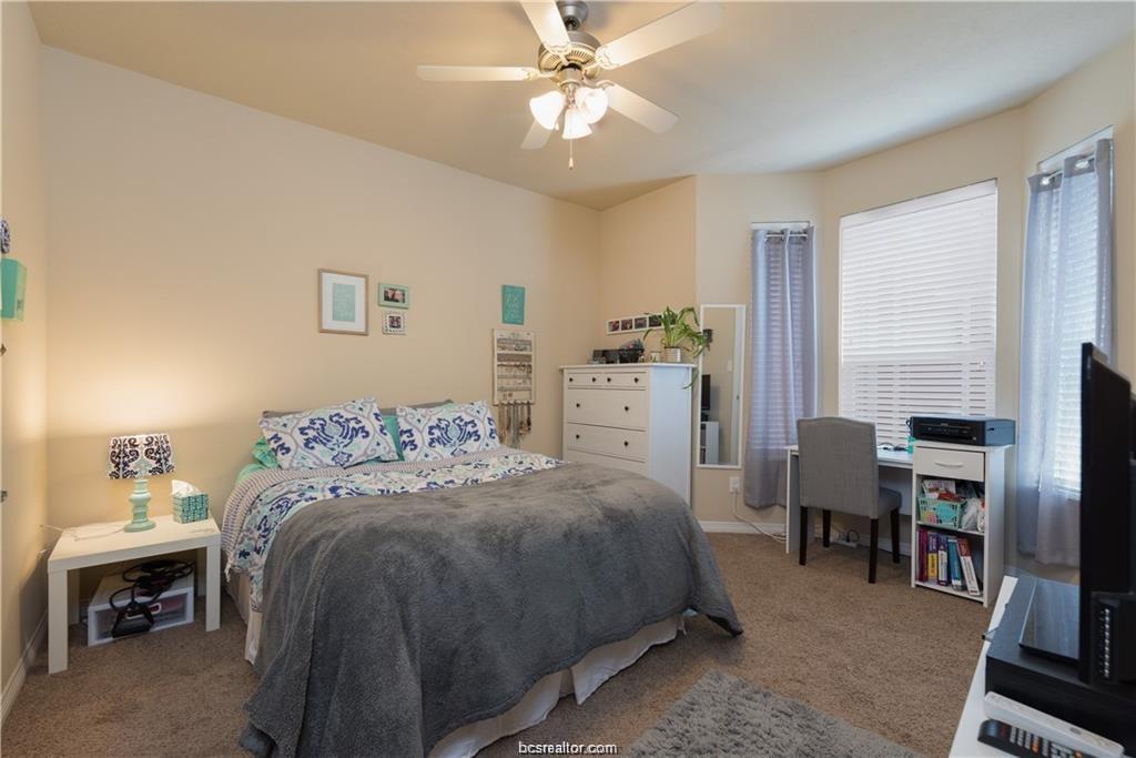1198 Jones-Butler Road, Unit 406 College Station, TX 77840 - Photo 9 of 12 a bedroom with a bed and a table in it