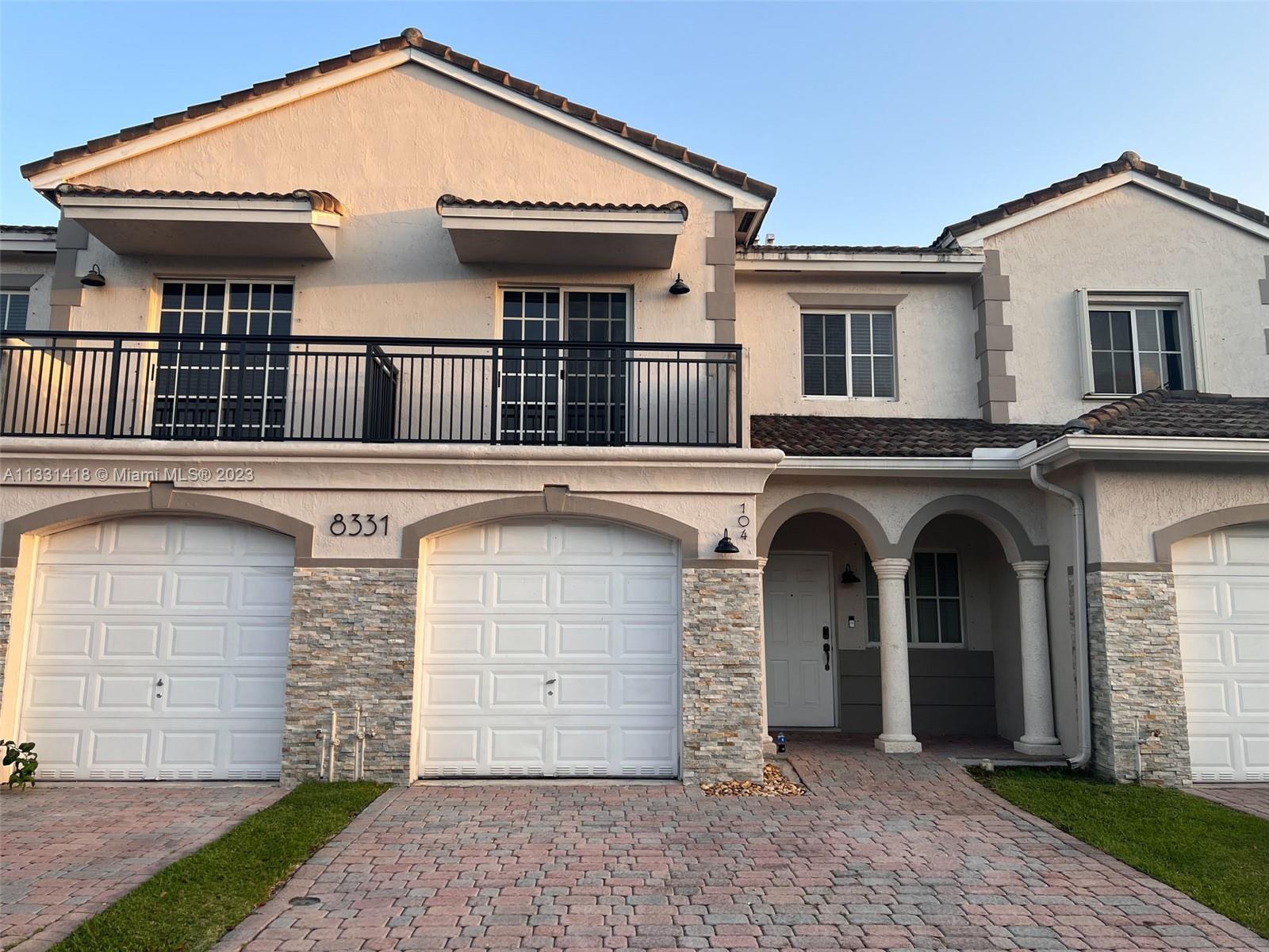 8331 Southwest 124th Avenue, Unit 10414 Miami, FL 33183 - Photo 1 of 12 a front view of a house with a garage