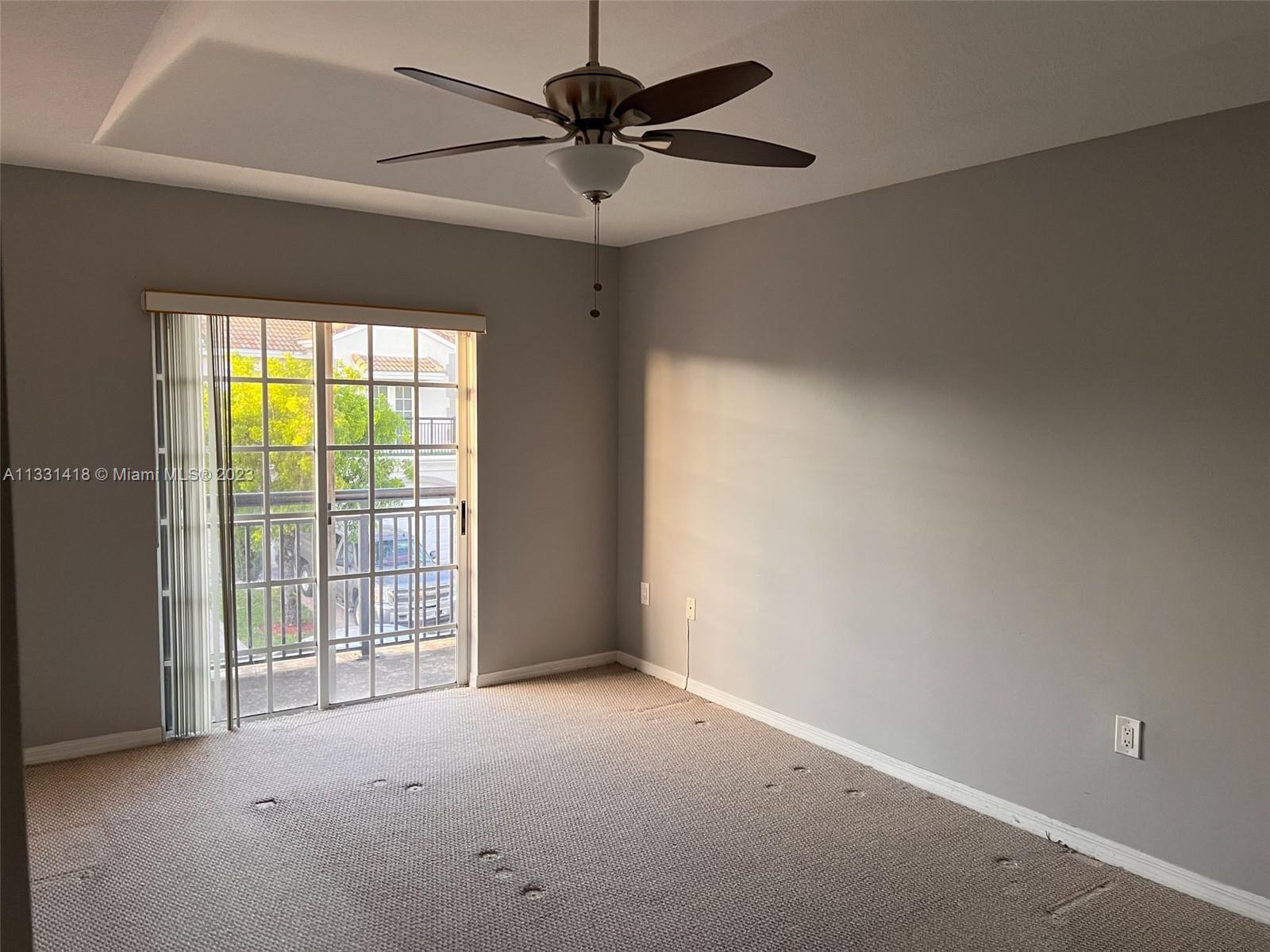 8331 Southwest 124th Avenue, Unit 10414 Miami, FL 33183 - Photo 7 of 12 a view of an empty room with a window