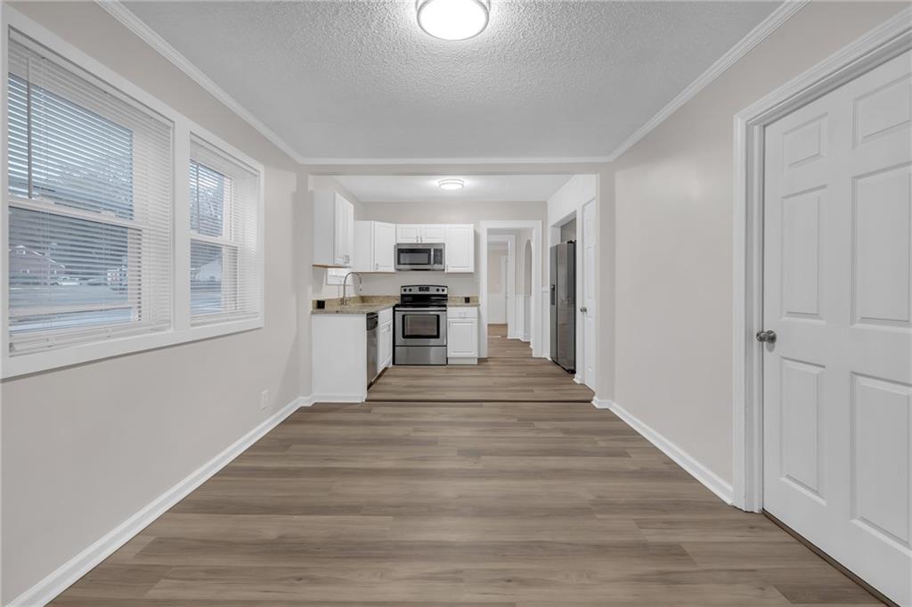 1683 Candler Road Decatur, GA 30032 - Photo 12 of 26 a view of a kitchen with wooden floor electronic appliances and windows