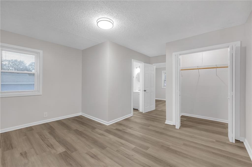 1683 Candler Road Decatur, GA 30032 - Photo 14 of 26 a view of an empty room with wooden floor and closet