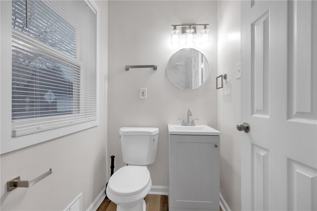 1683 Candler Road Decatur, GA 30032 - Photo 17 of 26 a white toilet sitting next to a bathroom sink