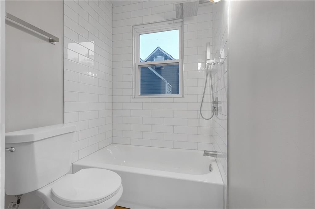 1683 Candler Road Decatur, GA 30032 - Photo 22 of 26 a bathroom with a toilet and a shower