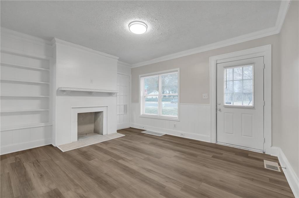 1683 Candler Road Decatur, GA 30032 - Photo 4 of 26 a view of empty room with a fireplace and wooden floor