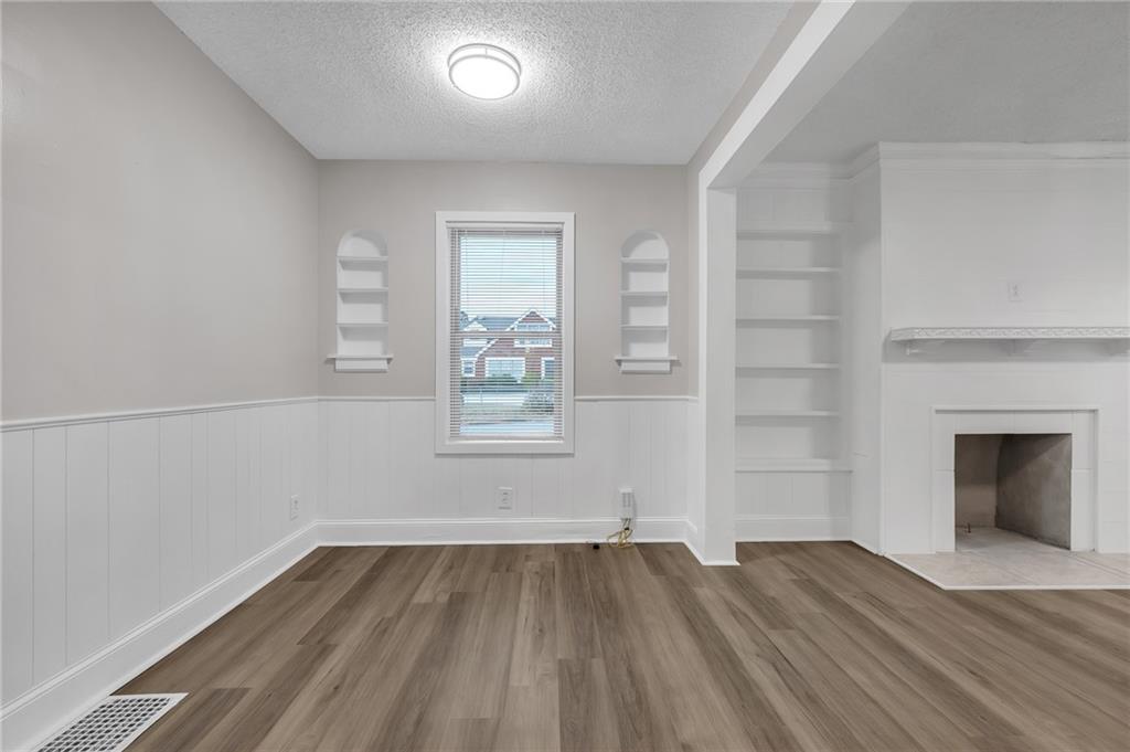 1683 Candler Road Decatur, GA 30032 - Photo 7 of 26 wooden floor in an empty room with a window