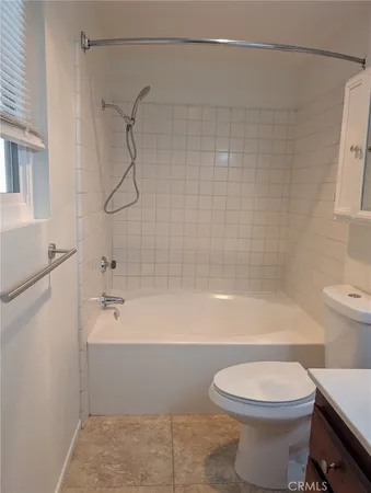 a bathroom with a bathtub and a toilet
