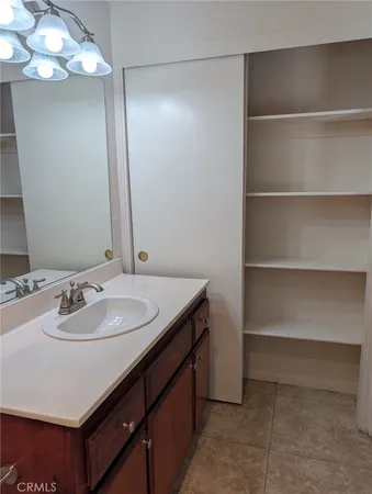 a bathroom with a sink vanity and a mirror