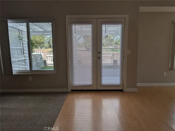 a view of wooden floor and windows in a room
