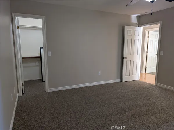 an empty room with closet and a window