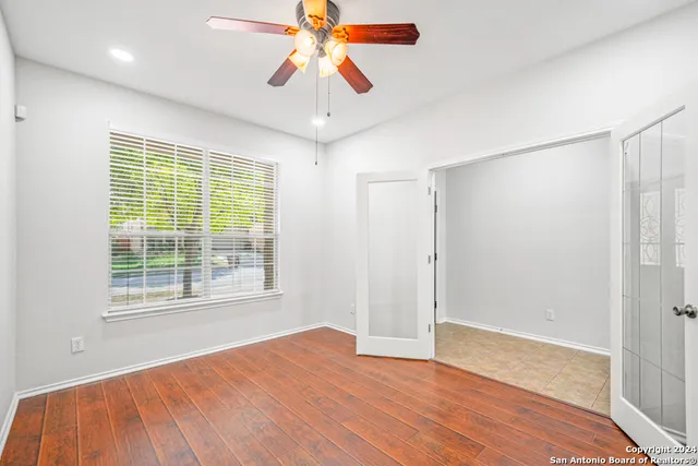 wooden floor in an empty room with a window