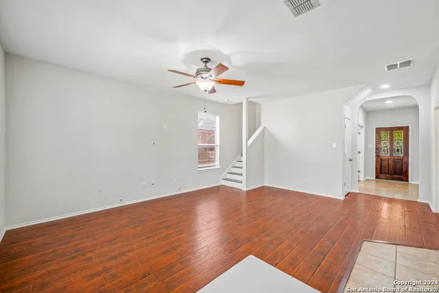 wooden floor in an empty room with a window