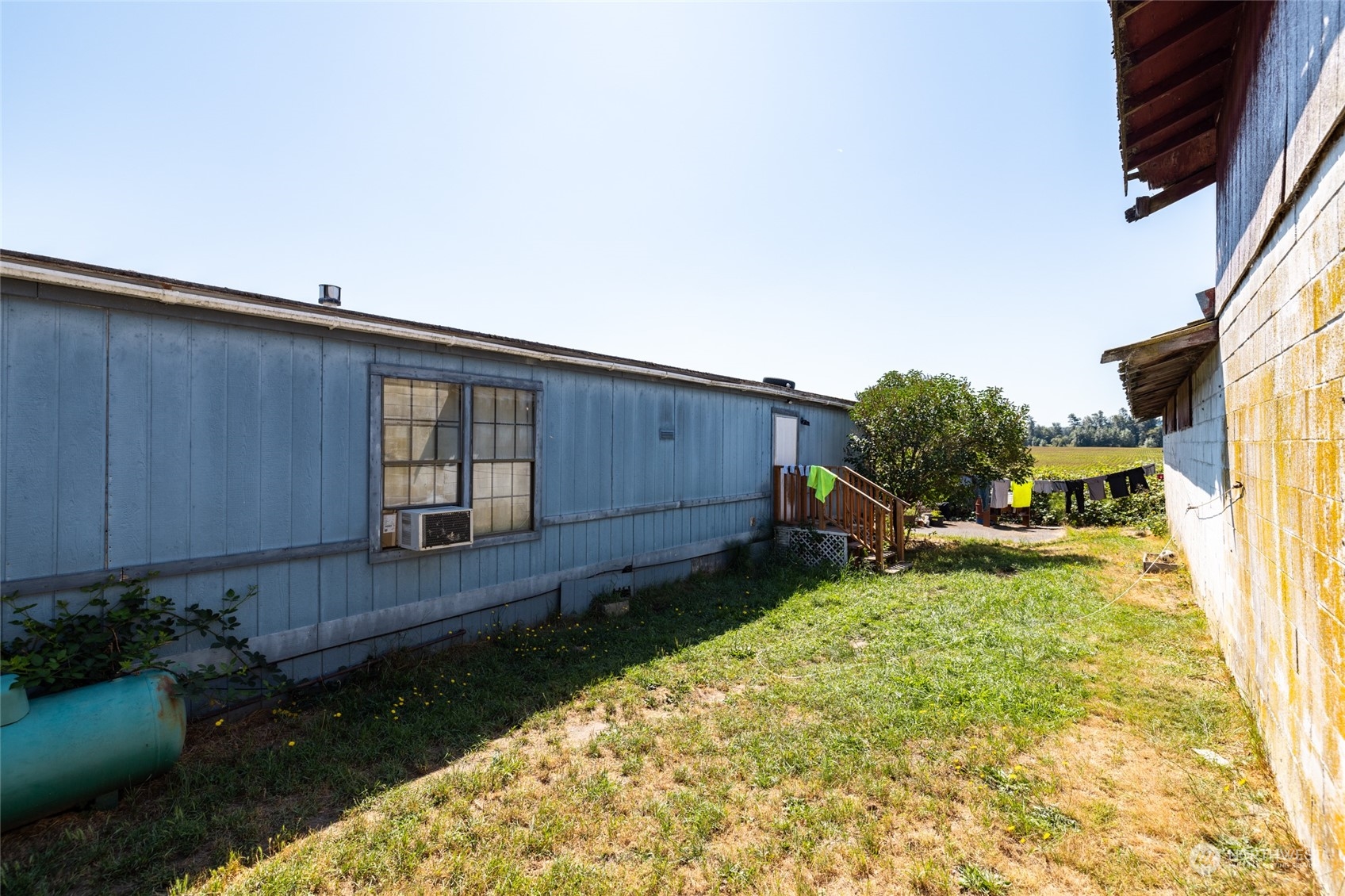 22648 Rhodes Road Sedro-Woolley, WA 98284 - Photo 10 of 13 a backyard of a house with wooden fence and plants