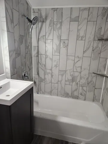 a bathroom with a bathtub and shower