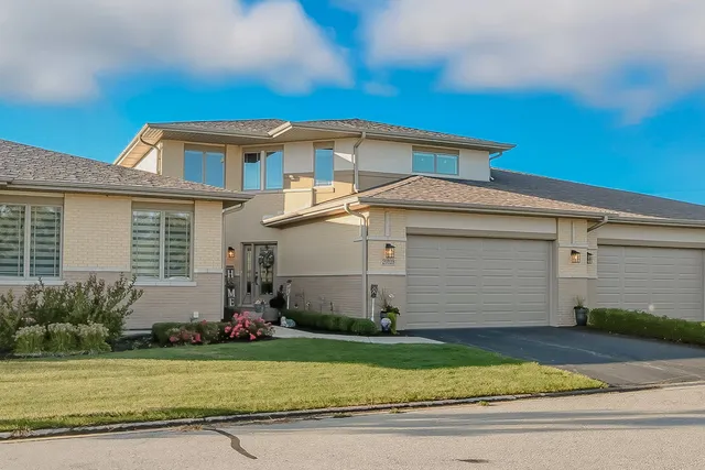 a front view of a house with a garden