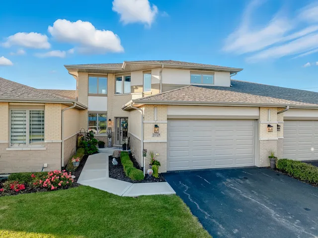 a front view of a house with a garden