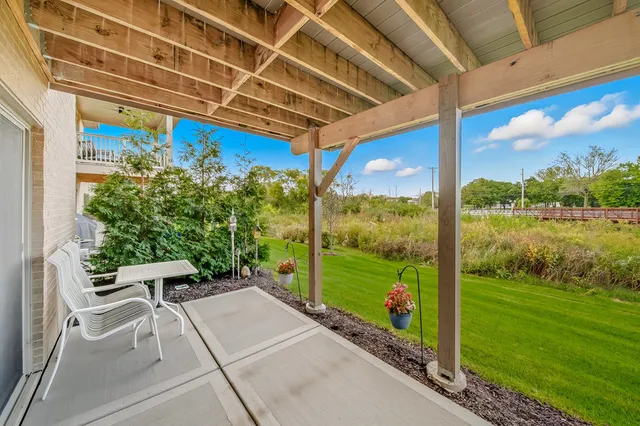 a view of a porch with furniture and garden