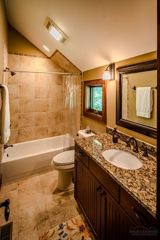 485 Woodlake Loop Road Elk Park, NC 28622 - Photo 26 of 44 a bathroom with a granite countertop bathtub sink vanity mirror and toilet