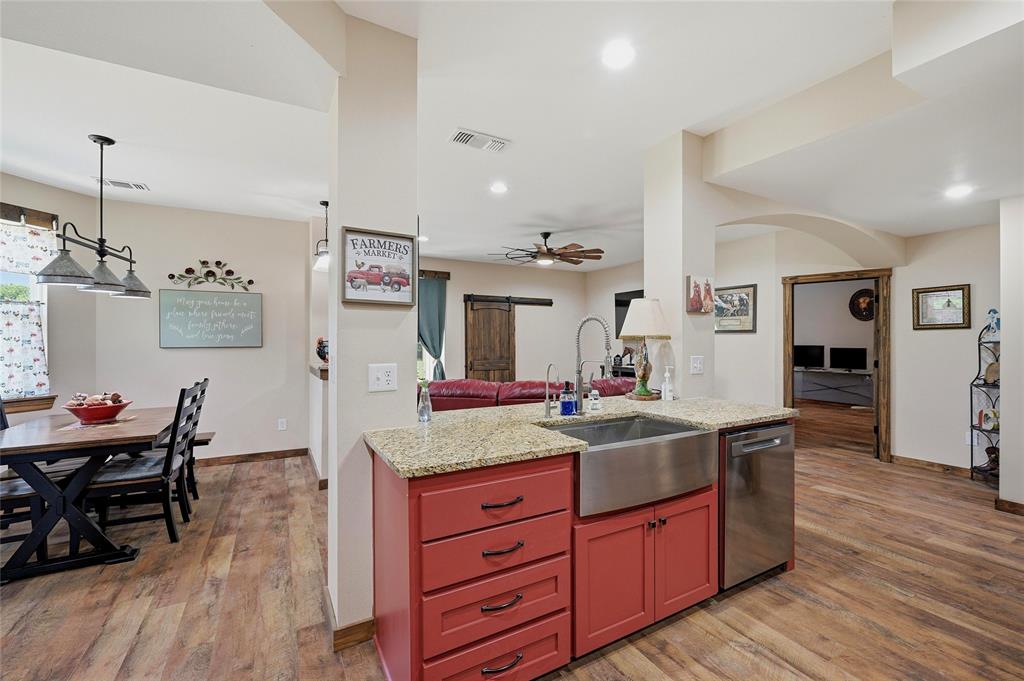 4652 Old Southmayd Road Sherman, TX 75092 - Photo 13 of 40 a kitchen with granite countertop dining room and wooden floor