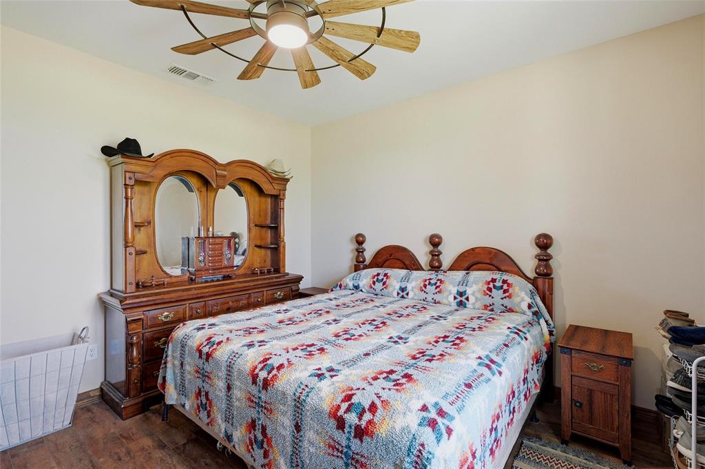 4652 Old Southmayd Road Sherman, TX 75092 - Photo 16 of 40 a bedroom with a bed and dresser