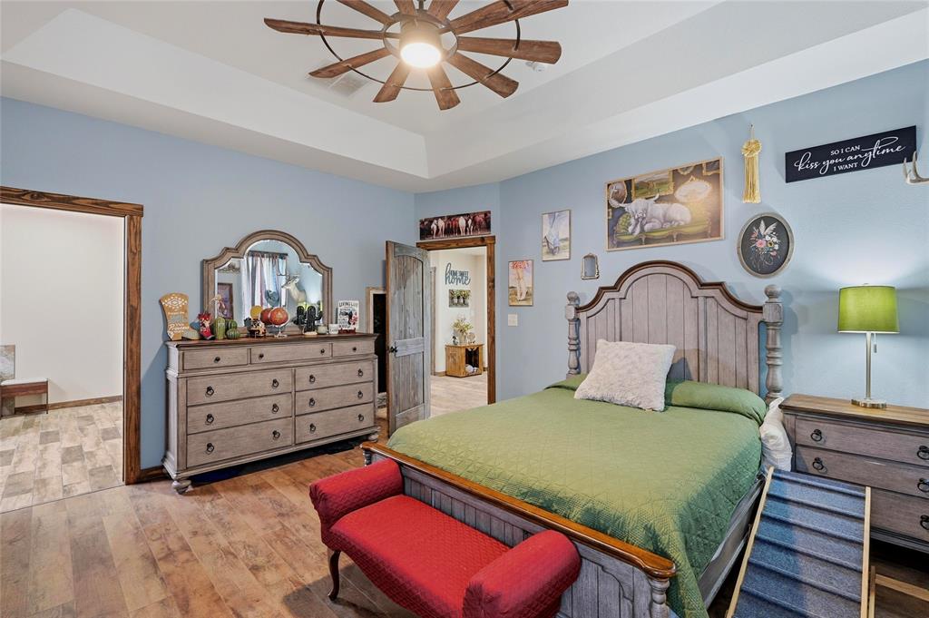 4652 Old Southmayd Road Sherman, TX 75092 - Photo 19 of 40 a bedroom with a bed and a dresser in it