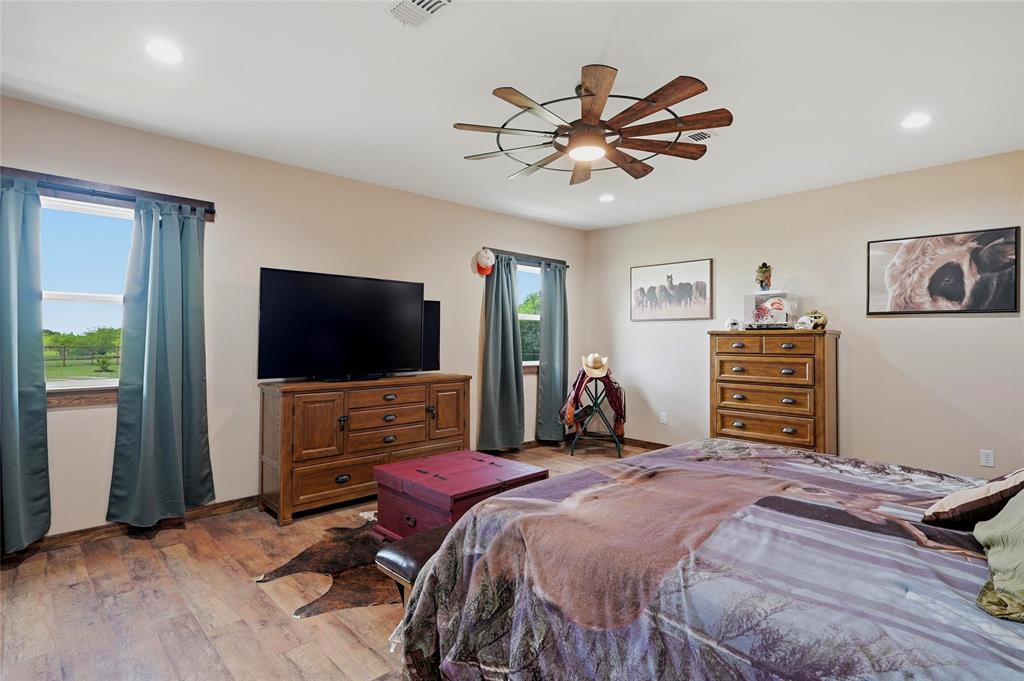 4652 Old Southmayd Road Sherman, TX 75092 - Photo 22 of 40 a bedroom with a bed and a flat screen tv