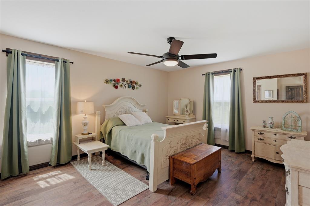 4652 Old Southmayd Road Sherman, TX 75092 - Photo 30 of 40 a bedroom with a bed and a chandelier