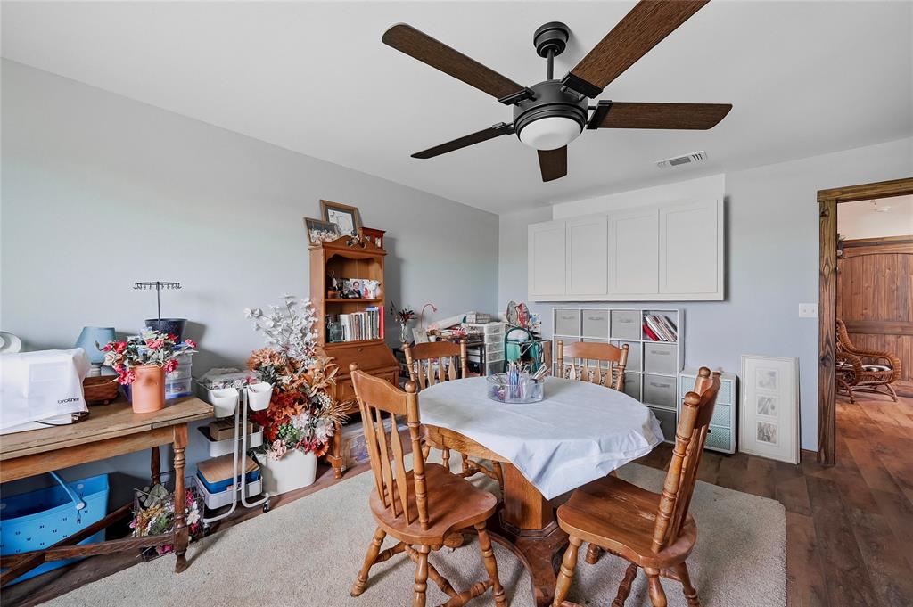 4652 Old Southmayd Road Sherman, TX 75092 - Photo 32 of 40 a dining room with furniture and a chandelier fan