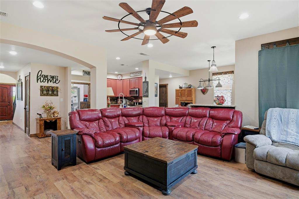 4652 Old Southmayd Road Sherman, TX 75092 - Photo 9 of 40 a living room with furniture a ceiling fan and a rug