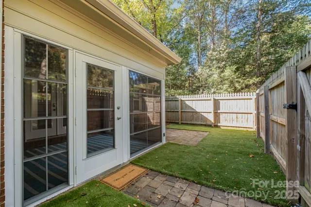 a view of a backyard with a large tree