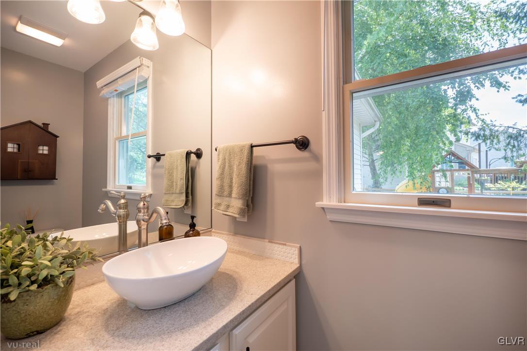 1640 Deer Path Road Easton, PA 18040 - Photo 15 of 39 a bathroom with a sink a mirror and a window