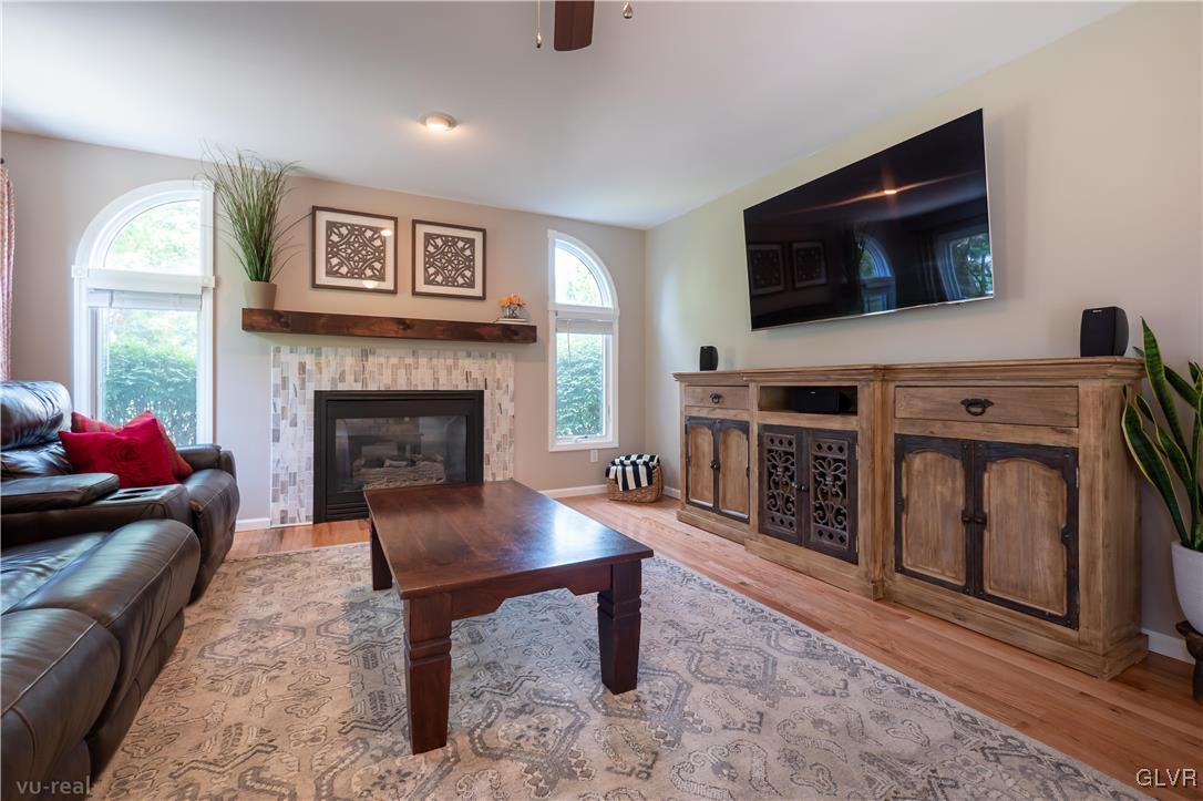 1640 Deer Path Road Easton, PA 18040 - Photo 16 of 39 a living room with furniture a flat screen tv and a fireplace