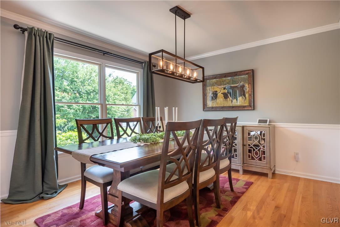 1640 Deer Path Road Easton, PA 18040 - Photo 6 of 39 a dining room with furniture a chandelier and wooden floor