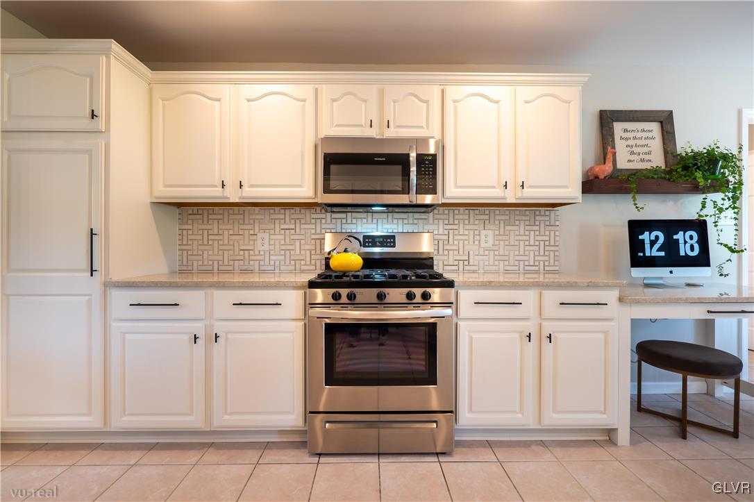 1640 Deer Path Road Easton, PA 18040 - Photo 9 of 39 a kitchen with stainless steel appliances granite countertop a stove a microwave and a refrigerator