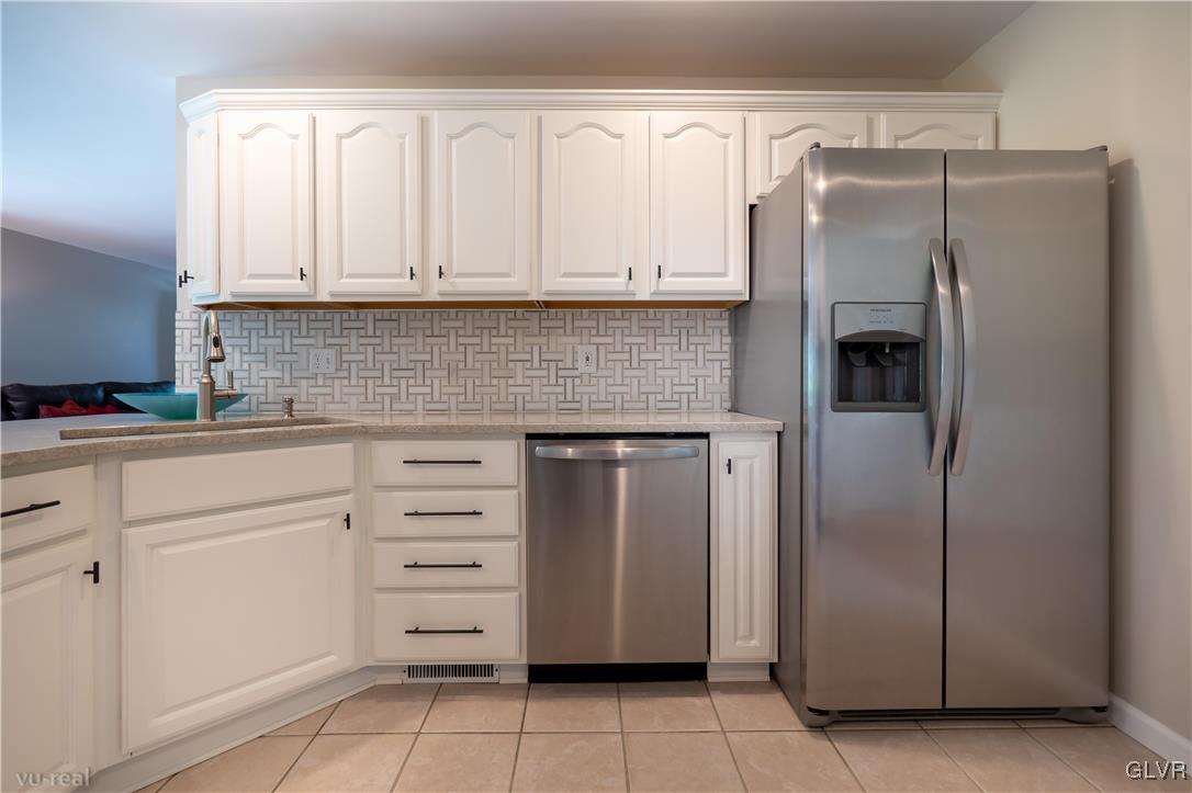 1640 Deer Path Road Easton, PA 18040 - Photo 10 of 39 a kitchen with white cabinets and stainless steel appliances