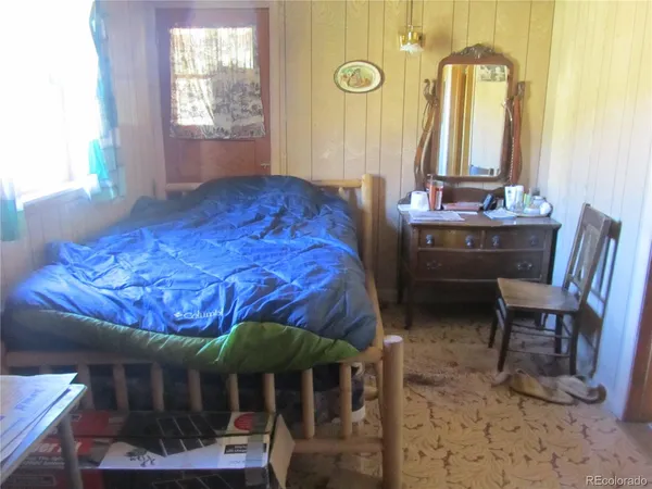 a bedroom with a bed and a table