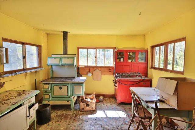 a living room with fireplace furniture and a window