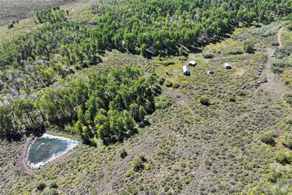 an aerial view of a houses with a yard