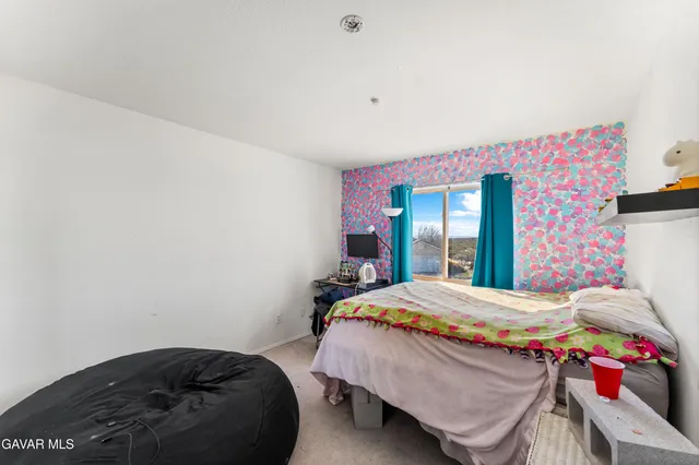 a bedroom with a bed and a table