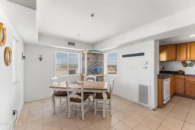a dining room with furniture and window