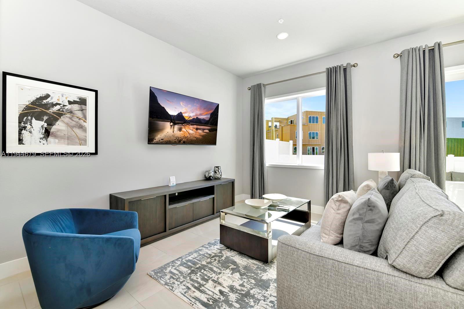 7740 Sandy Ridge Drive, Unit 136 Kissimmee, FL 34747 - Photo 1 of 26 a living room with furniture and a flat screen tv