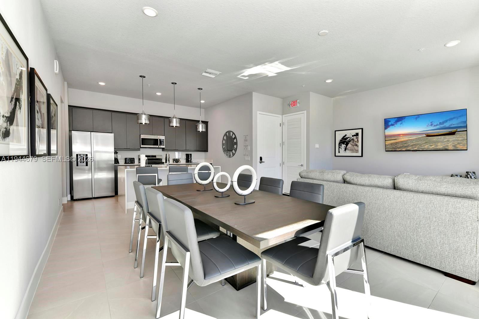 7740 Sandy Ridge Drive, Unit 136 Kissimmee, FL 34747 - Photo 11 of 26 a view of a dining room with furniture and a kitchen