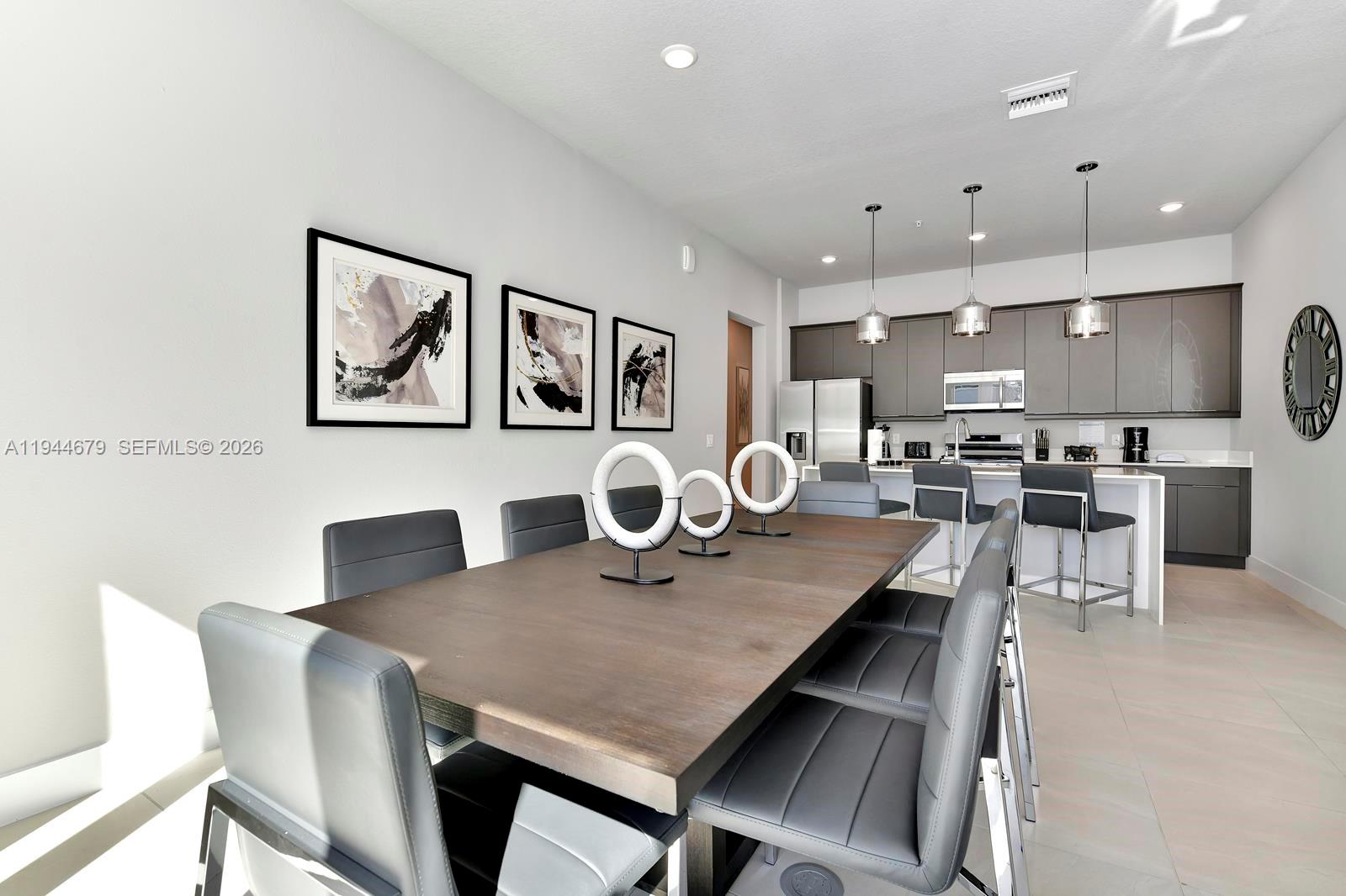 7740 Sandy Ridge Drive, Unit 136 Kissimmee, FL 34747 - Photo 13 of 26 a view of a dining room with furniture and wooden floor