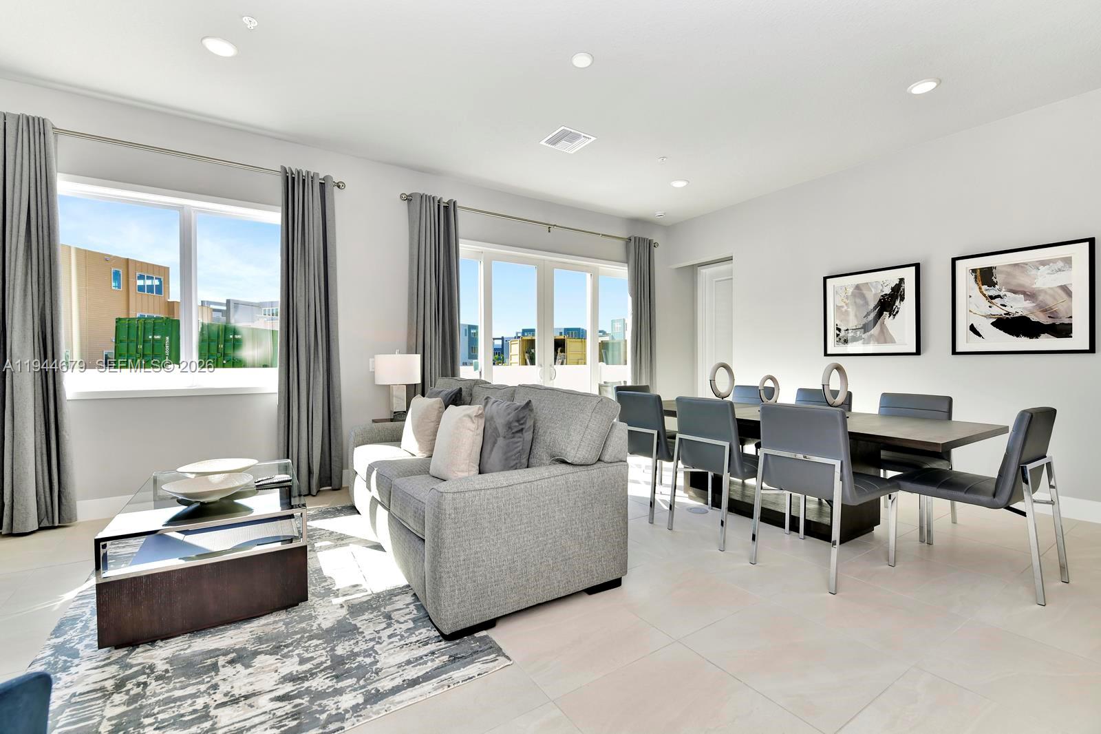 7740 Sandy Ridge Drive, Unit 136 Kissimmee, FL 34747 - Photo 2 of 26 a living room with furniture kitchen view and a window