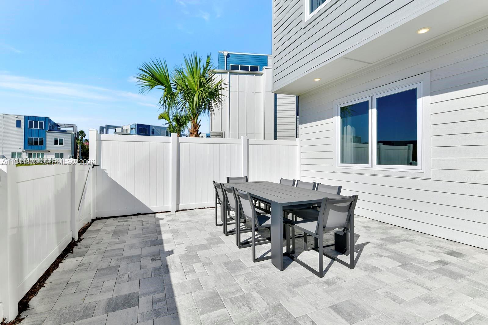 7740 Sandy Ridge Drive, Unit 136 Kissimmee, FL 34747 - Photo 24 of 26 a view of a dinning table and chairs in the patio