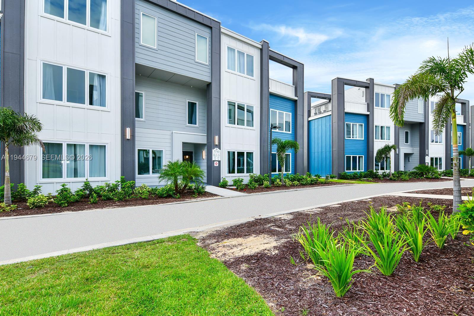 7740 Sandy Ridge Drive, Unit 136 Kissimmee, FL 34747 - Photo 25 of 26 a front view of a brick house with a yard
