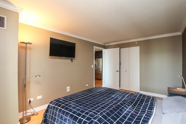 a bedroom with a bed and a flat screen tv