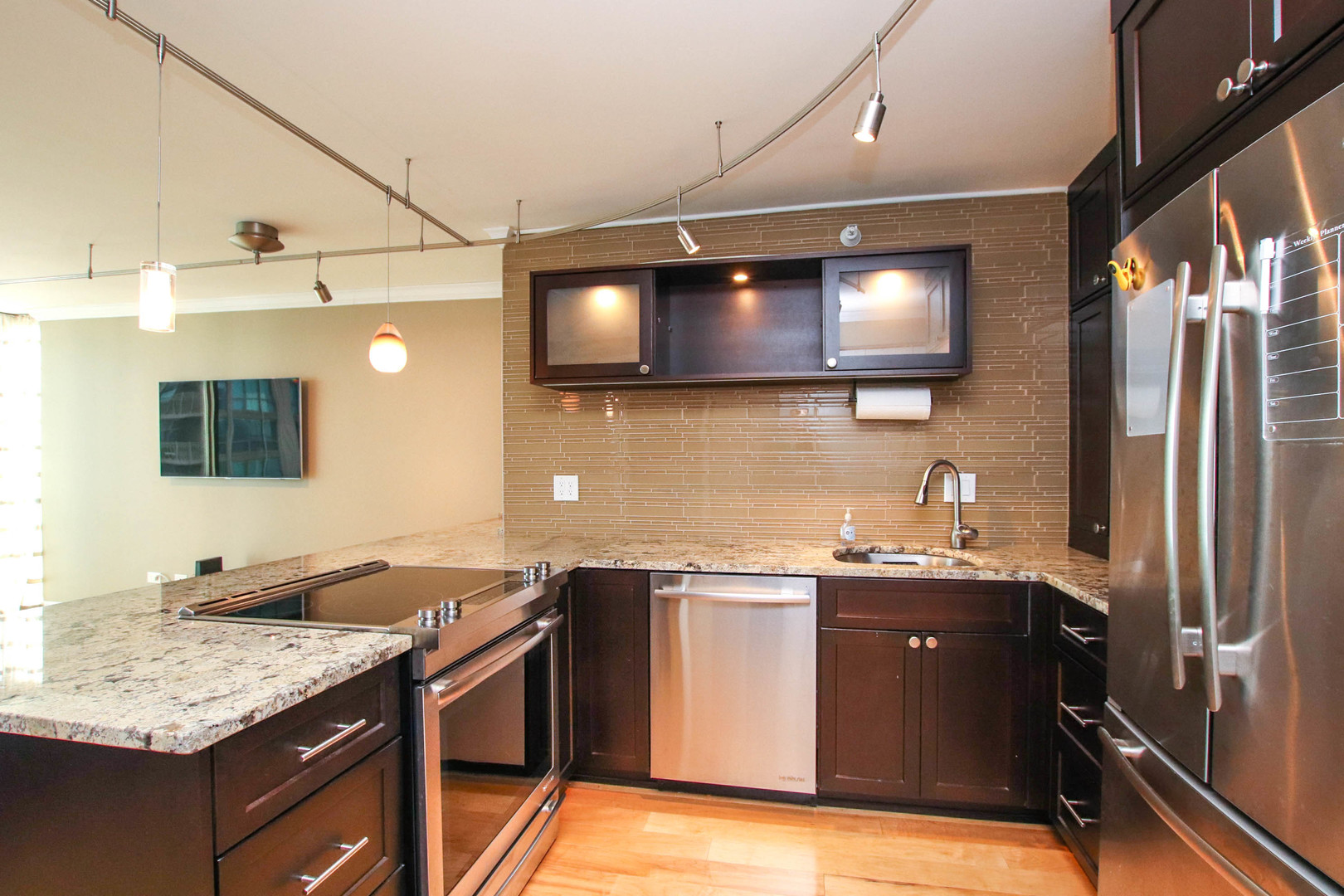2 East Erie Street, Unit 2101 Chicago, IL 60611 - Photo 3 of 19 a kitchen with stainless steel appliances granite countertop a sink stove and refrigerator